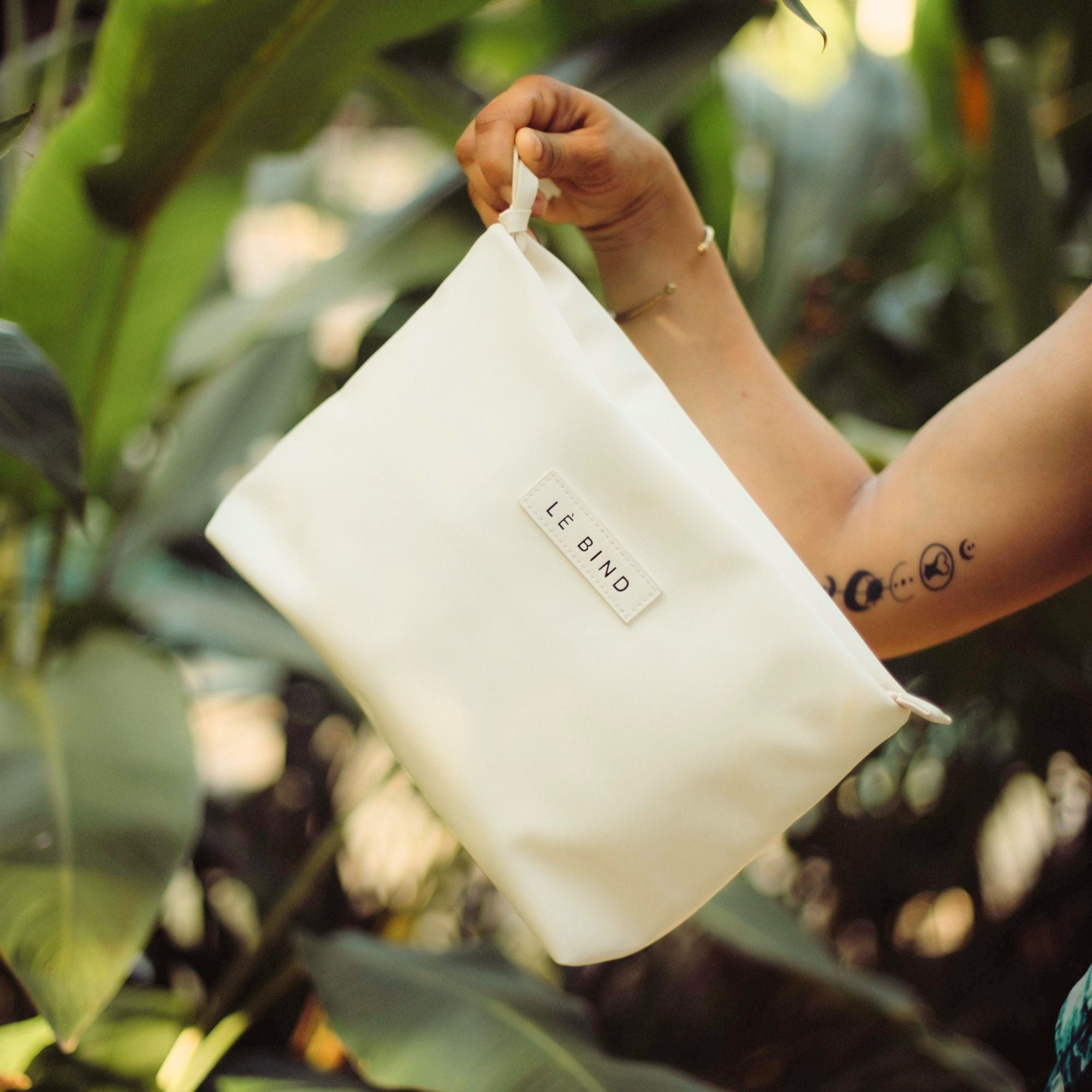 Mom holding a Bellibind Le Bind Purse, a stylish push present and mom essentials bag.