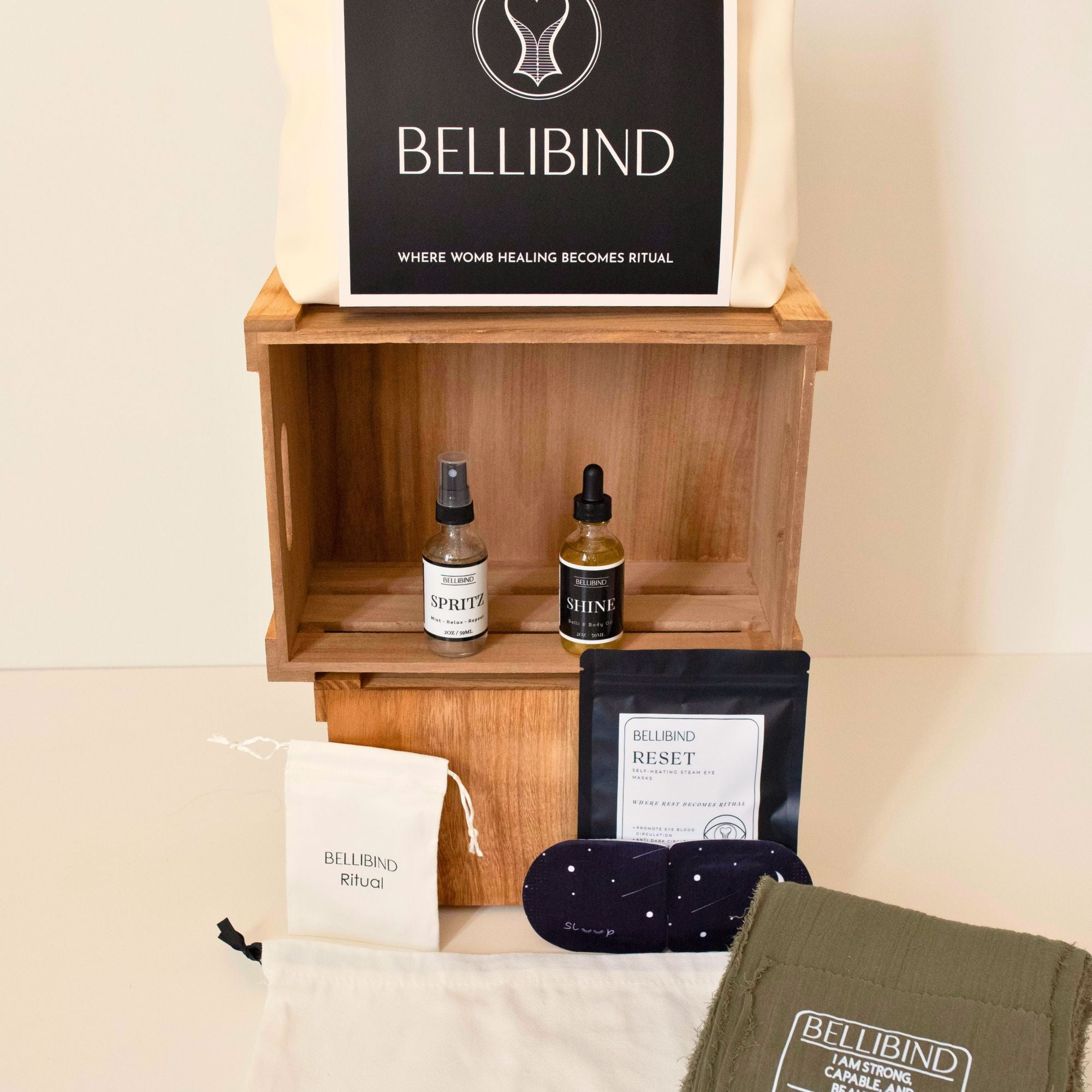Bellibind Mom Deserves The Purse collection display with a belly binding wrap and postpartum recovery essentials.